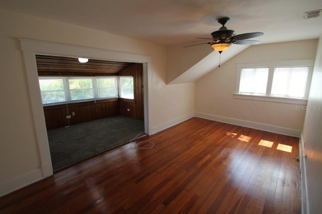 additional living space featuring ceiling fan, dark hardwood / wood-style flooring, and vaulted ceiling