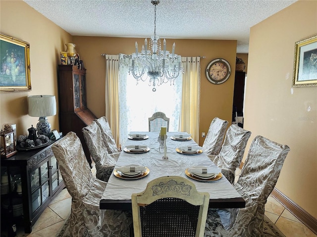 dining space featuring tile patterned floors, a textured ceiling, and a notable chandelier