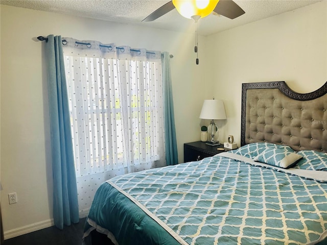 bedroom with a textured ceiling and ceiling fan