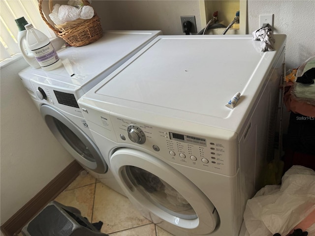 washroom with tile patterned floors and washing machine and clothes dryer