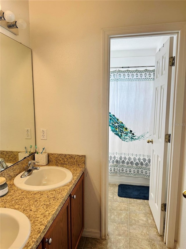 bathroom featuring dual bowl vanity and tile patterned floors