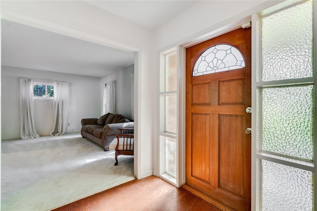 foyer entrance with carpet