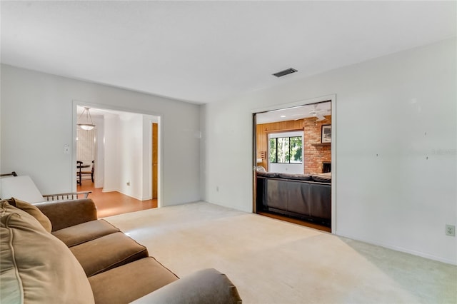 living room featuring light colored carpet and a fireplace