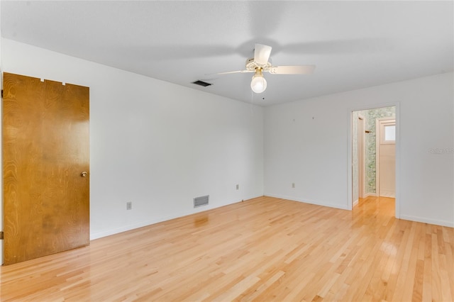 empty room with ceiling fan and light hardwood / wood-style floors