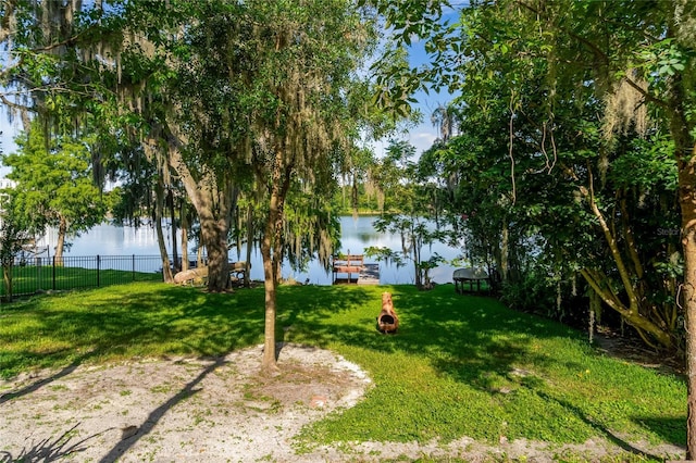 view of yard featuring a boat dock and a water view