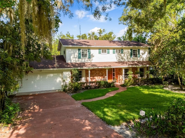 view of front of home with a front yard and a garage