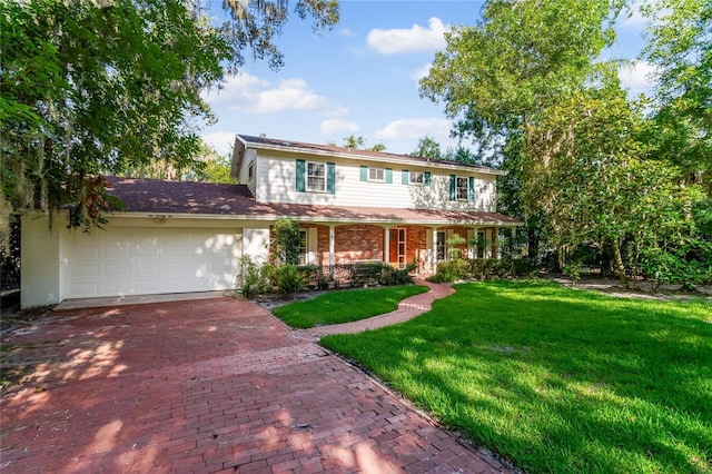 view of front of property featuring a garage and a front lawn