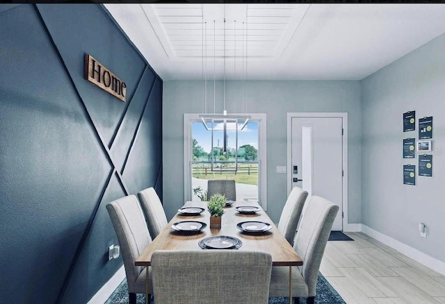 dining area with light tile patterned flooring and an inviting chandelier