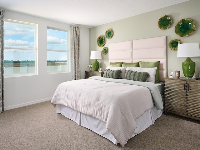 bedroom with a water view and carpet floors