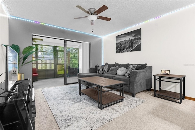 living room with ceiling fan and a textured ceiling