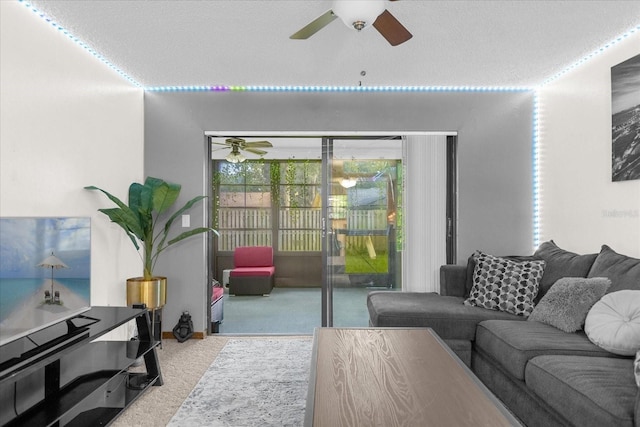 carpeted living room featuring a textured ceiling and ceiling fan