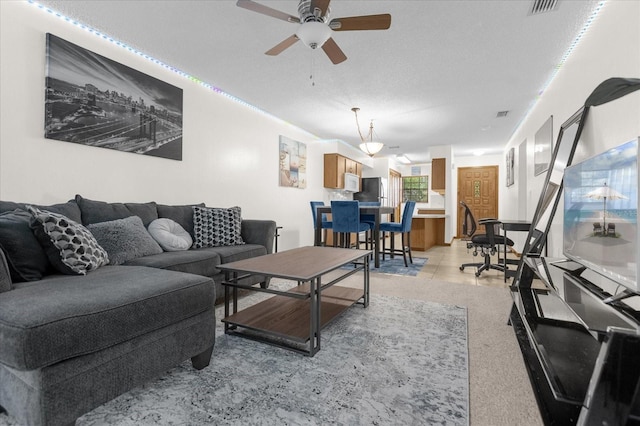 tiled living room featuring ceiling fan