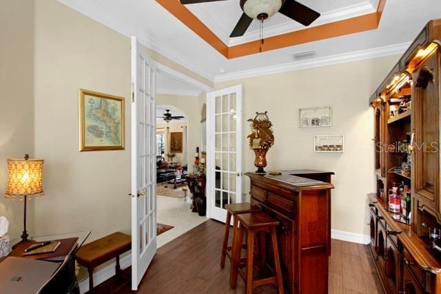 interior space with ornamental molding, dark wood-type flooring, and french doors