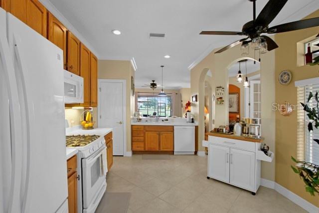 kitchen featuring kitchen peninsula, ornamental molding, white appliances, ceiling fan, and light tile patterned flooring