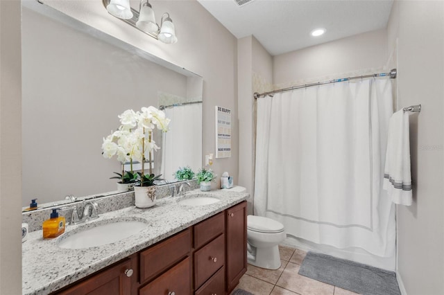 bathroom featuring tile patterned floors, vanity, and toilet