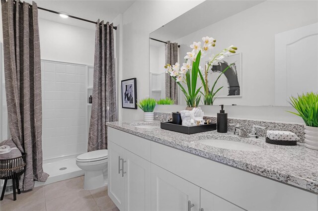 bathroom featuring tile patterned flooring, toilet, vanity, and a shower with shower curtain