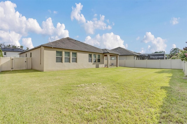 back of property featuring a lawn