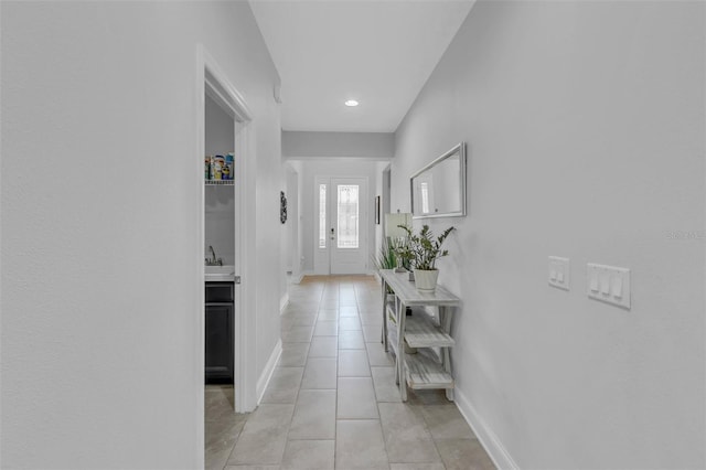 corridor featuring light tile patterned floors