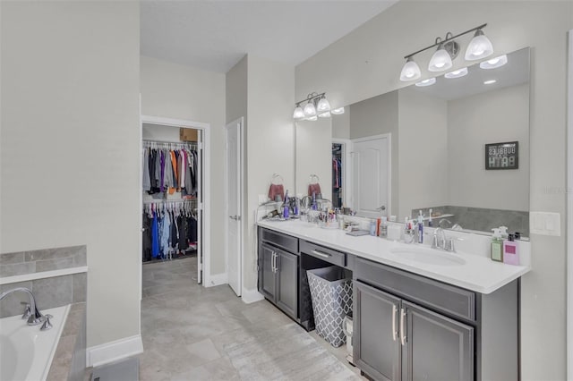 bathroom featuring a washtub, vanity, and tile patterned flooring