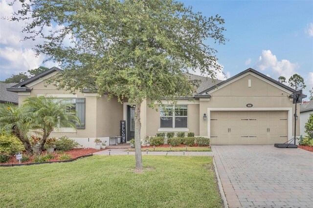 view of front of house featuring a garage and a front yard