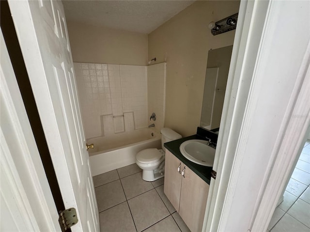 bathroom featuring a textured ceiling, bathtub / shower combination, toilet, tile patterned flooring, and vanity