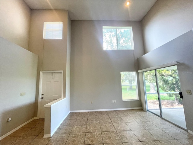 spare room with a towering ceiling