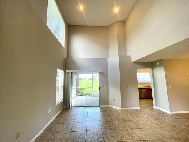 spare room featuring a high ceiling and sink