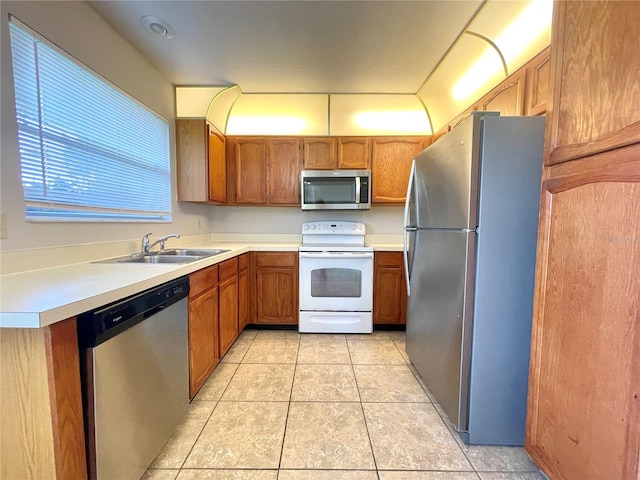 kitchen with light tile patterned floors, sink, and appliances with stainless steel finishes