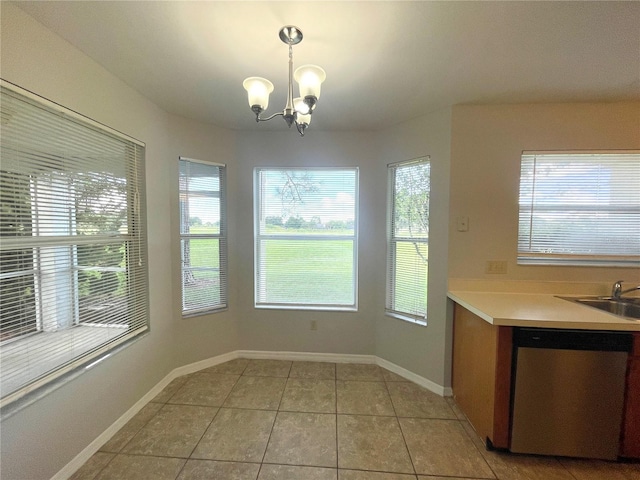 unfurnished dining area with sink, a healthy amount of sunlight, and light tile patterned flooring