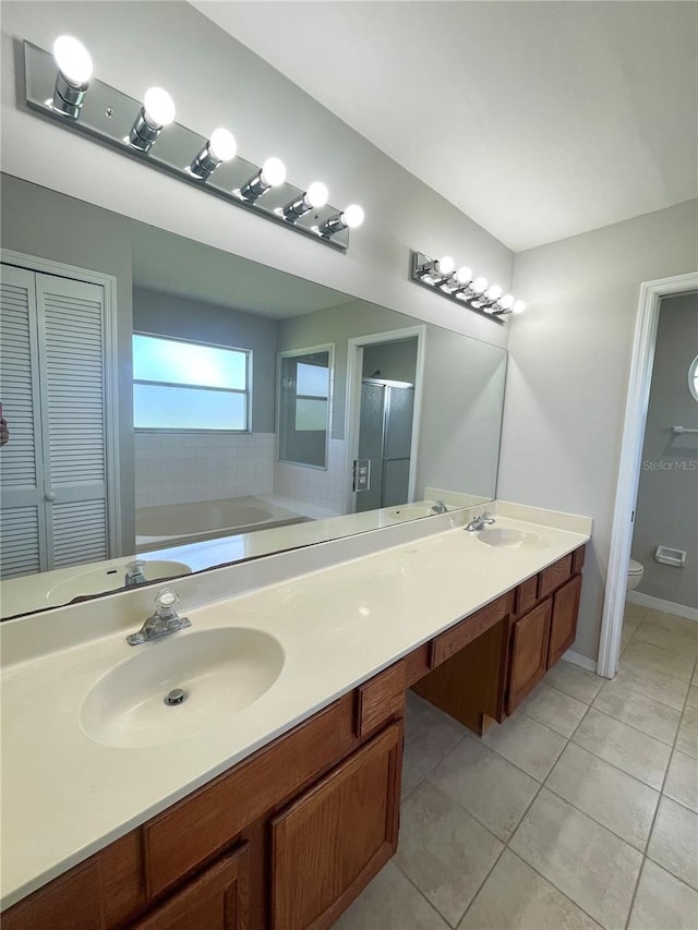 full bathroom with toilet, independent shower and bath, tile patterned floors, and vanity