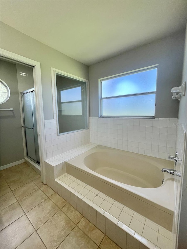 bathroom with tile patterned floors and shower with separate bathtub