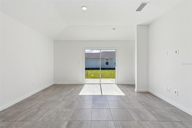 tiled empty room featuring baseboards and visible vents