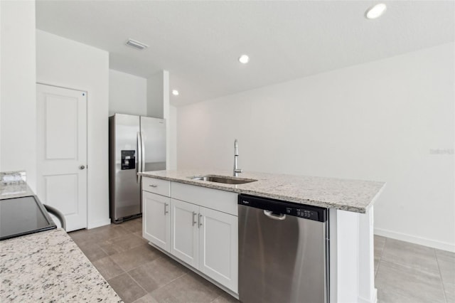 kitchen featuring a sink, visible vents, white cabinetry, appliances with stainless steel finishes, and an island with sink