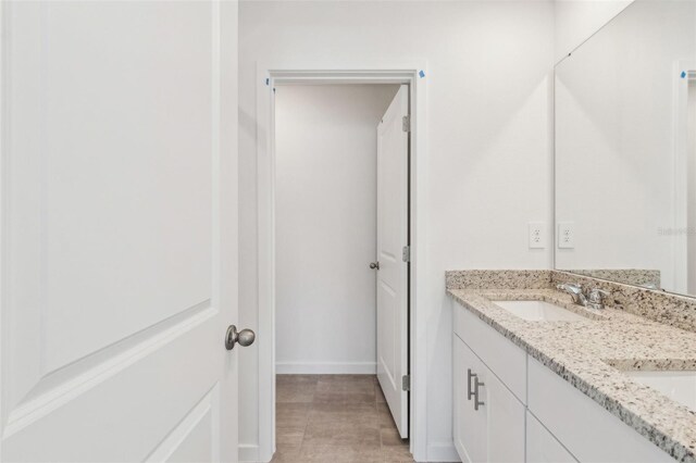 bathroom with a sink and double vanity