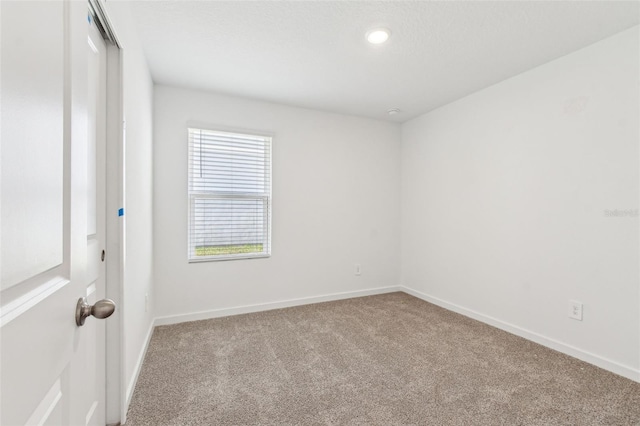 empty room with carpet flooring and baseboards