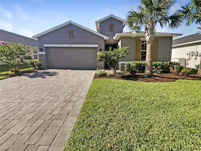 view of front facade with a garage and a front yard