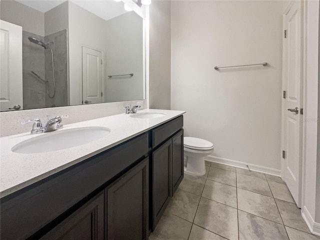 bathroom with tile patterned flooring, vanity, toilet, and a shower