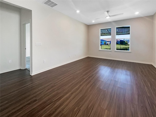 spare room featuring ceiling fan and dark wood-type flooring