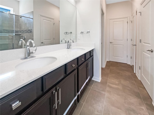 bathroom with tile patterned flooring, vanity, and walk in shower