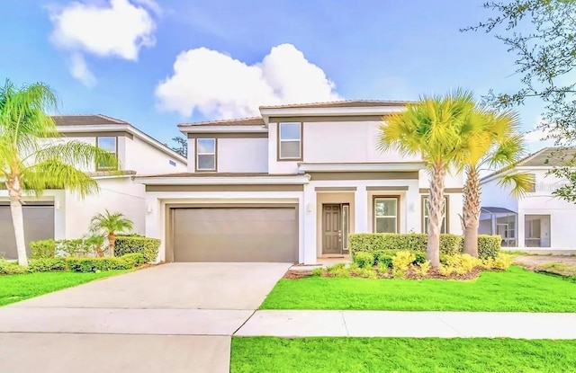 view of front of house with a front yard, an attached garage, driveway, and stucco siding