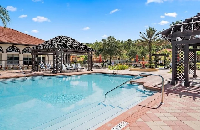 view of swimming pool featuring a patio and a gazebo