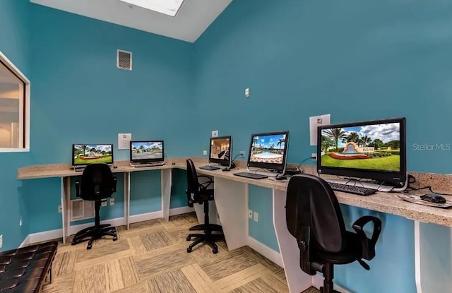 home office featuring built in desk and vaulted ceiling