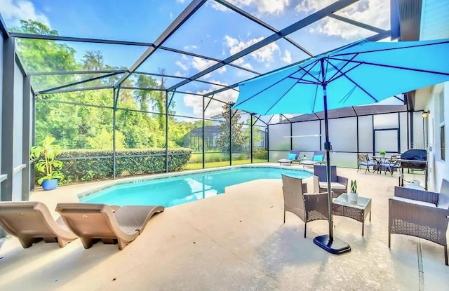 view of swimming pool featuring a patio area and a lanai