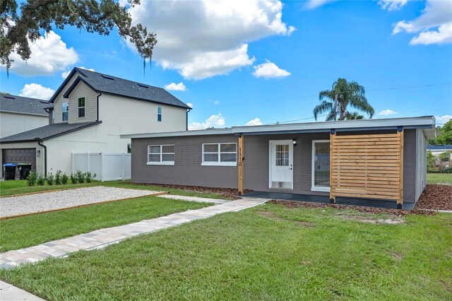 rear view of house featuring a yard