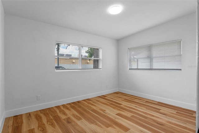 empty room with light hardwood / wood-style flooring