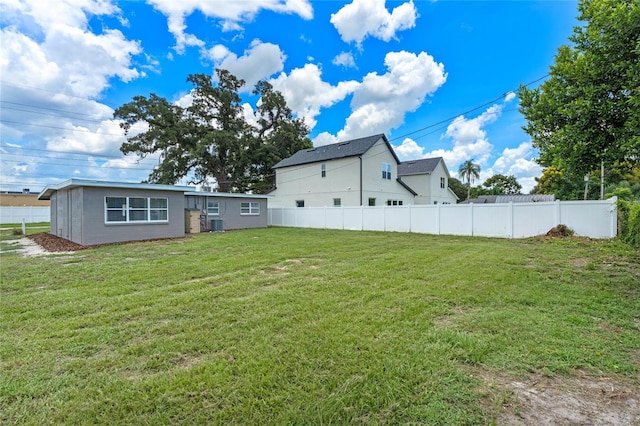 back of house featuring a lawn