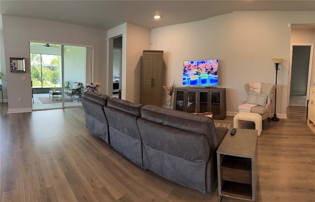 living room with hardwood / wood-style flooring and ceiling fan