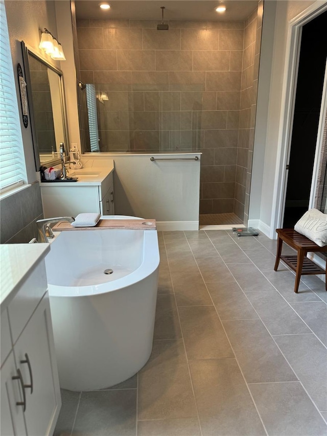 bathroom with tile patterned flooring, vanity, and separate shower and tub