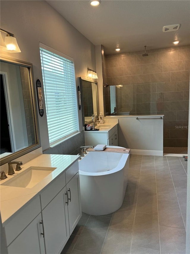 bathroom featuring tile patterned flooring, vanity, and independent shower and bath