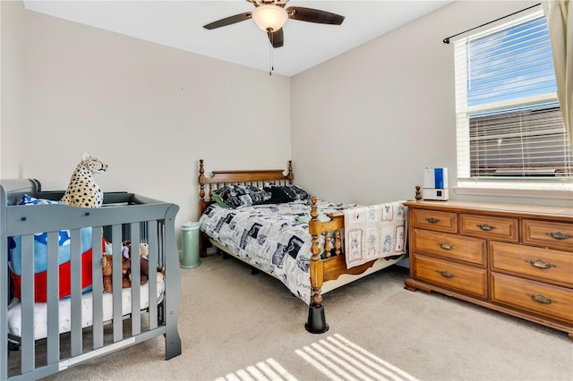 bedroom featuring ceiling fan and light colored carpet